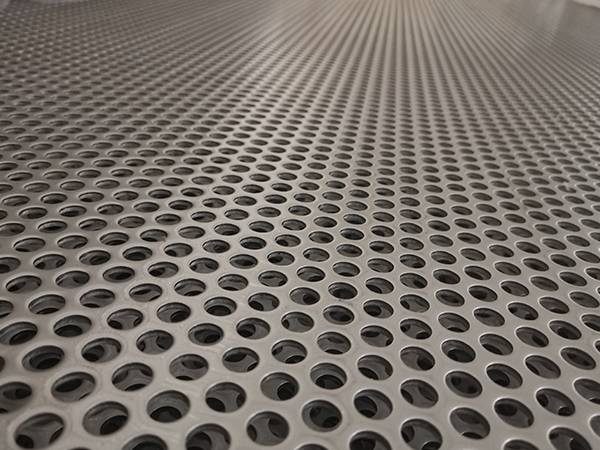 Multiple layers of stainless steel perforated sheets with round holes stacked together
